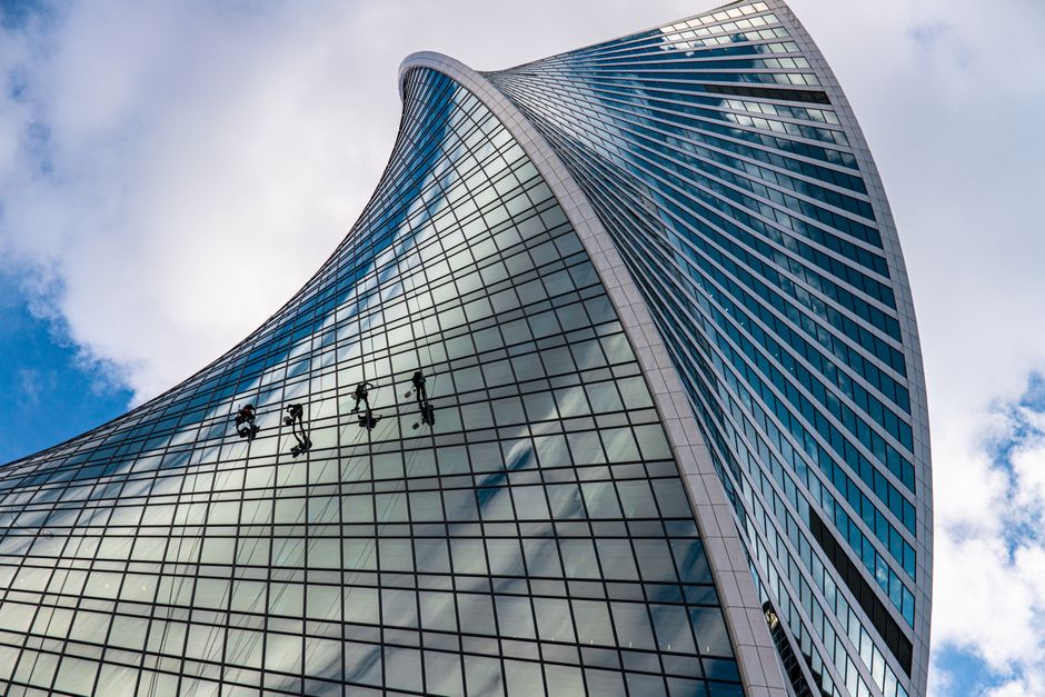 Low angle view of professionals cleaning the iconic Evolution Tower in Moscow.